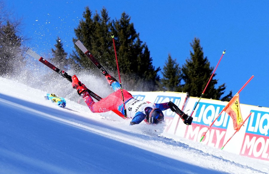 A skier falls during a race.