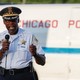 Chicago Police District Commander Kenneth Johnson, wearing his uniform and holding a microphone, speaks during an anti-violence rally in Chicago in July.