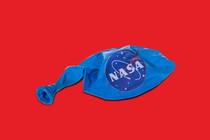 A deflated balloon with the NASA logo on it.