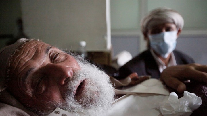 An old man infected with cholera lies on the bed at a hospital in Sanaa, Yemen on May 12, 2017.