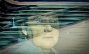 Angela Merkel stares out a car window.