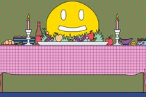 A Thanksgiving table full of food, featuring a giant smiley face in place of a turkey