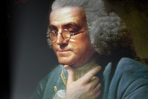 A portrait of Benjamin Franklin, in which he is staring into the glow of a smartphone screen.