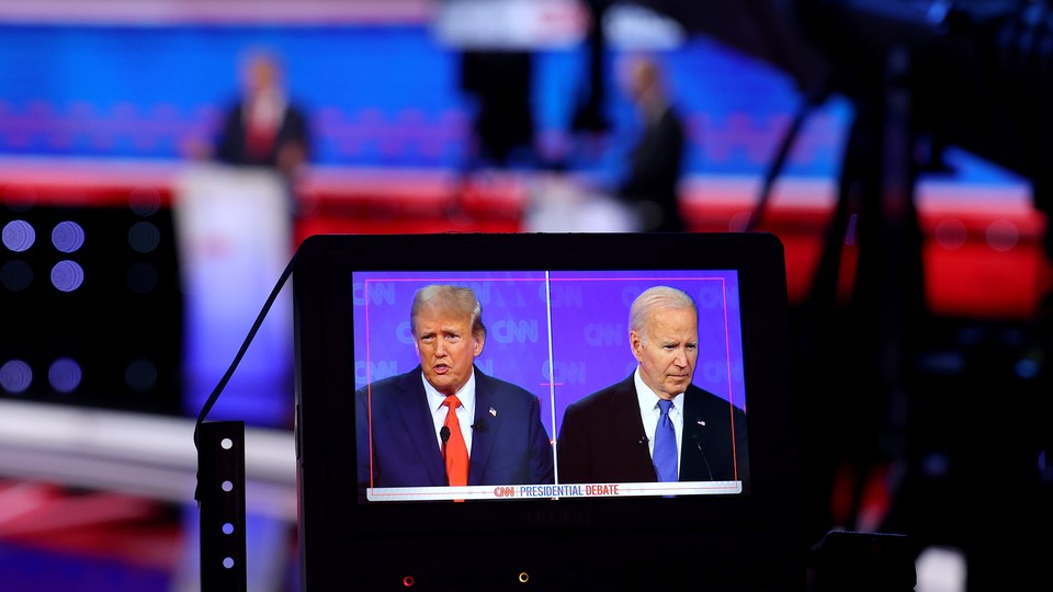 A monitor shows Trump and Biden during the first 2024 presidential debate