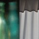 a diptych, with a blurred photo of teal bottles on the left, and black and white photo of a curtain on the right
