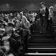 A black-and-white photo of Iowans caucusing