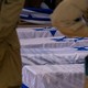 Soldiers looking solemnly at graves covered in Israeli flags