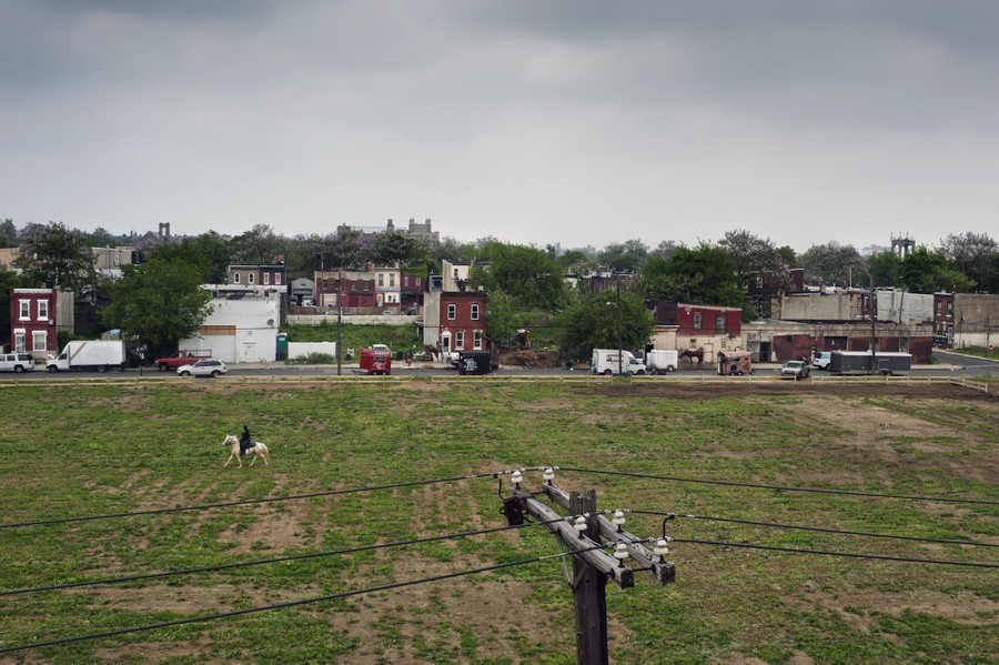 Carleb Carter, 22, takes a ride across the street from the stables with his nephew Marquan, 4, on Thursday, May 22, 2014.