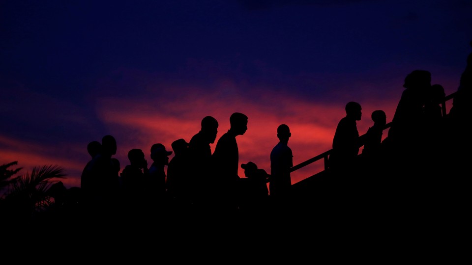 Participants arrive to a night vigil during a commemoration ceremony marking the 25th anniversary of the Rwandan genocide, in Kigali, Rwanda on April 7, 2019