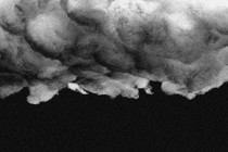 Photo illustration of storm clouds over a black sky.