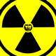 An illustration of a Ionizing radiation symbol with a black-and-white photo of Vladimir Putin in the center.