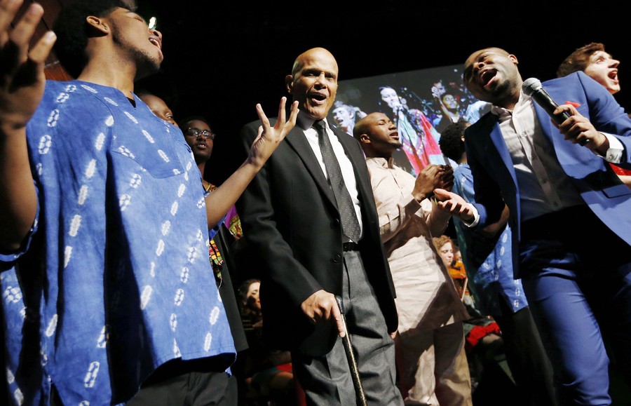 Harry Belafonte sings with students and faculty members.