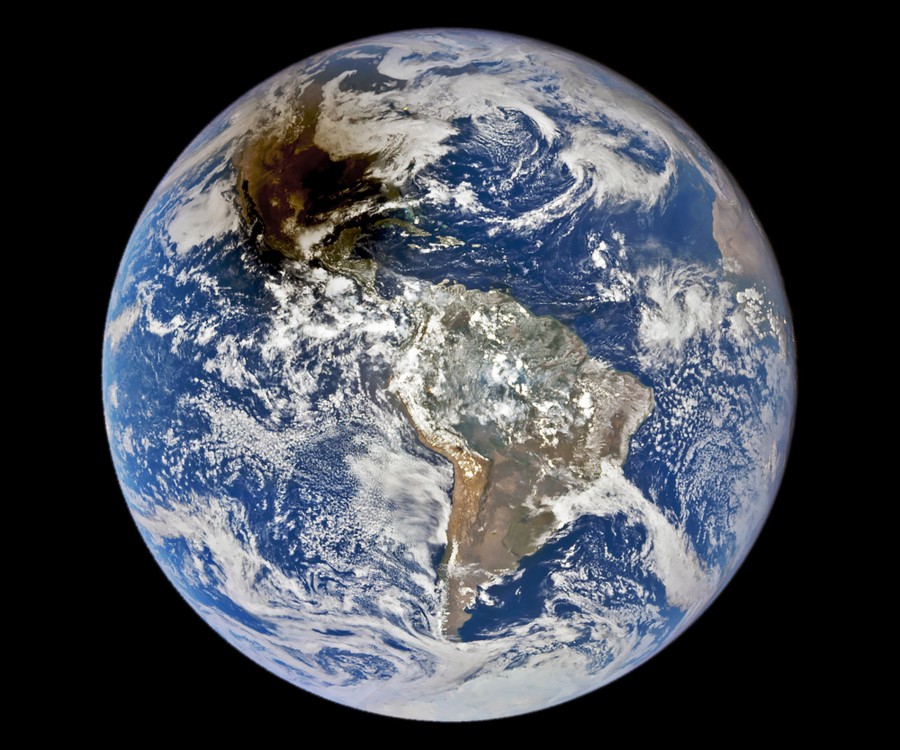 A view of the entire Earth from space, with most of North America darkened by a shadow.