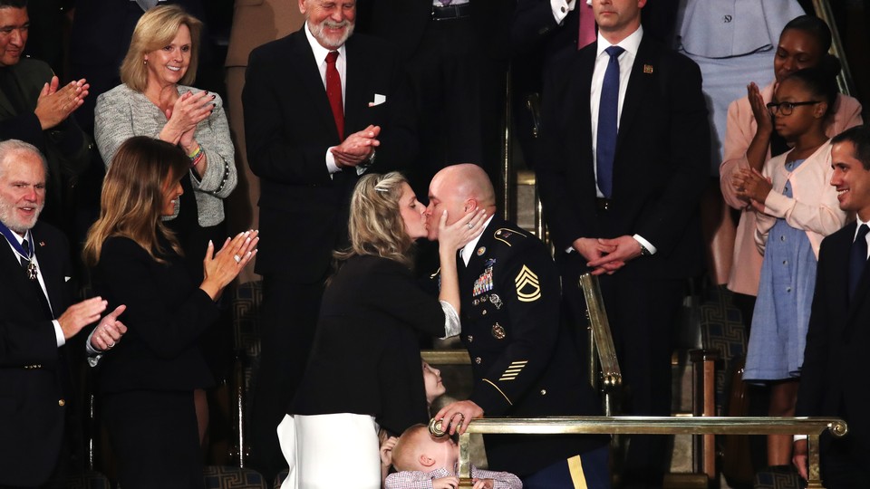 Amy Williams and Army Sgt. 1st Class Townsend Williams kiss at the State of the Union address