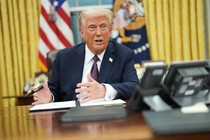 Photo of Donald Trump signing an executive order at the Resolute desk in the Oval Office