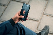 A man displays a picture of President Trump on his phone.