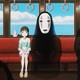 Chihiro and No Face sitting on the mysterious train line in 'Spirited Away'