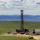 A drilling rig backed by mountains in Wyoming