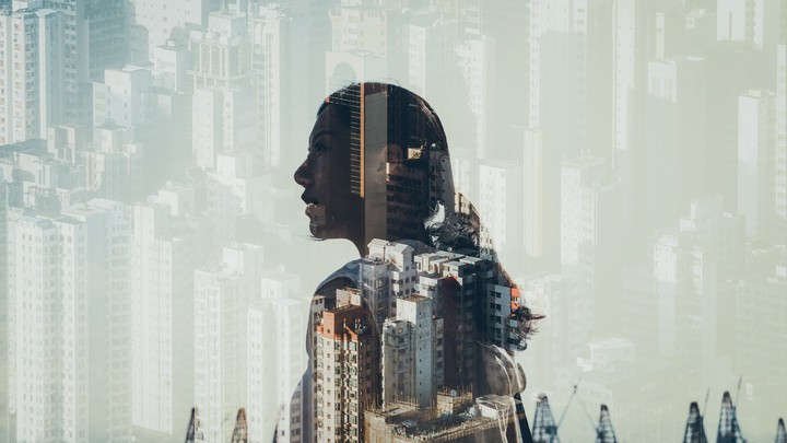 Woman's silhouette against cityscape