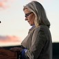 A profile photograph of Liz Cheney standing at a podium, speaking about her future political plans after her 2022 primary defeat
