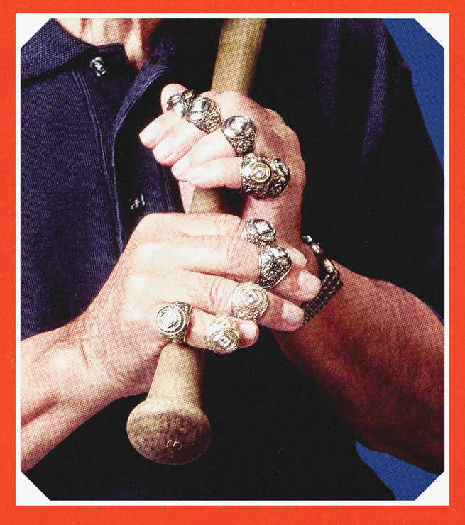 close-up photo of two hands holding wooden baseball bat, with large ring on each finger