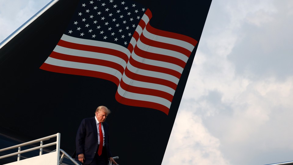 Trump in front of an American flag
