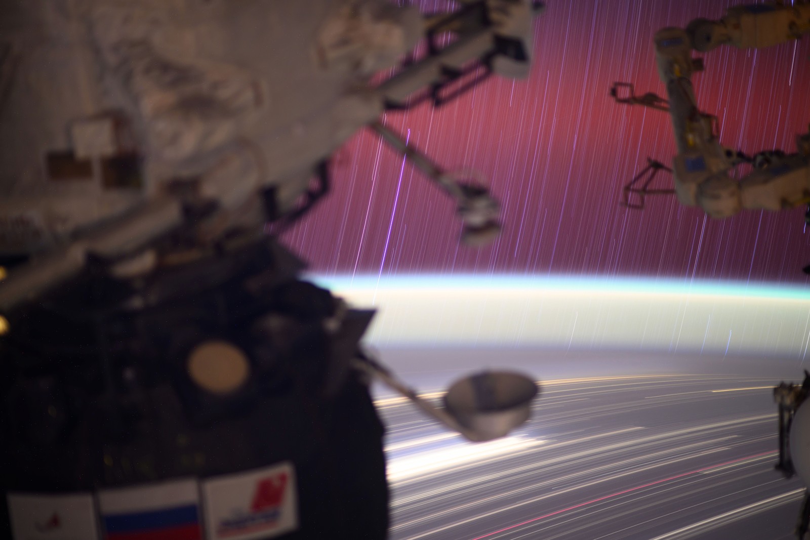 A long-exposure view of the lights of Earth and the stars above