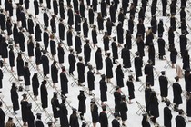 Rows of cap-and-gown-clad graduates