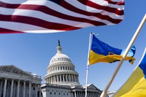 The Capitol building with an American flag and Ukrainian flag framing the shot