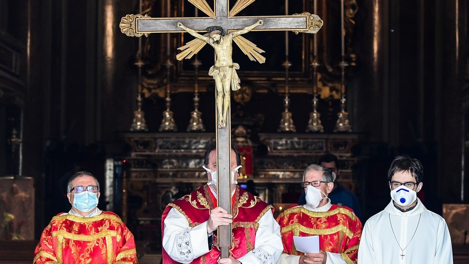 Parish priest wearing a face mask.