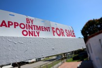 A real-estate sign is displayed in front of a home on February 22, 2023, in Miami, Florida.