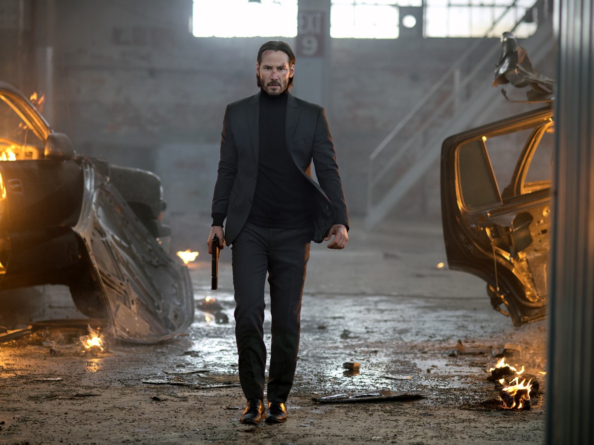 The movie John Wick 2. John wears a dirty white shirt. This is because all his clothes and his washer were burned up when they blew up his house. His dog is