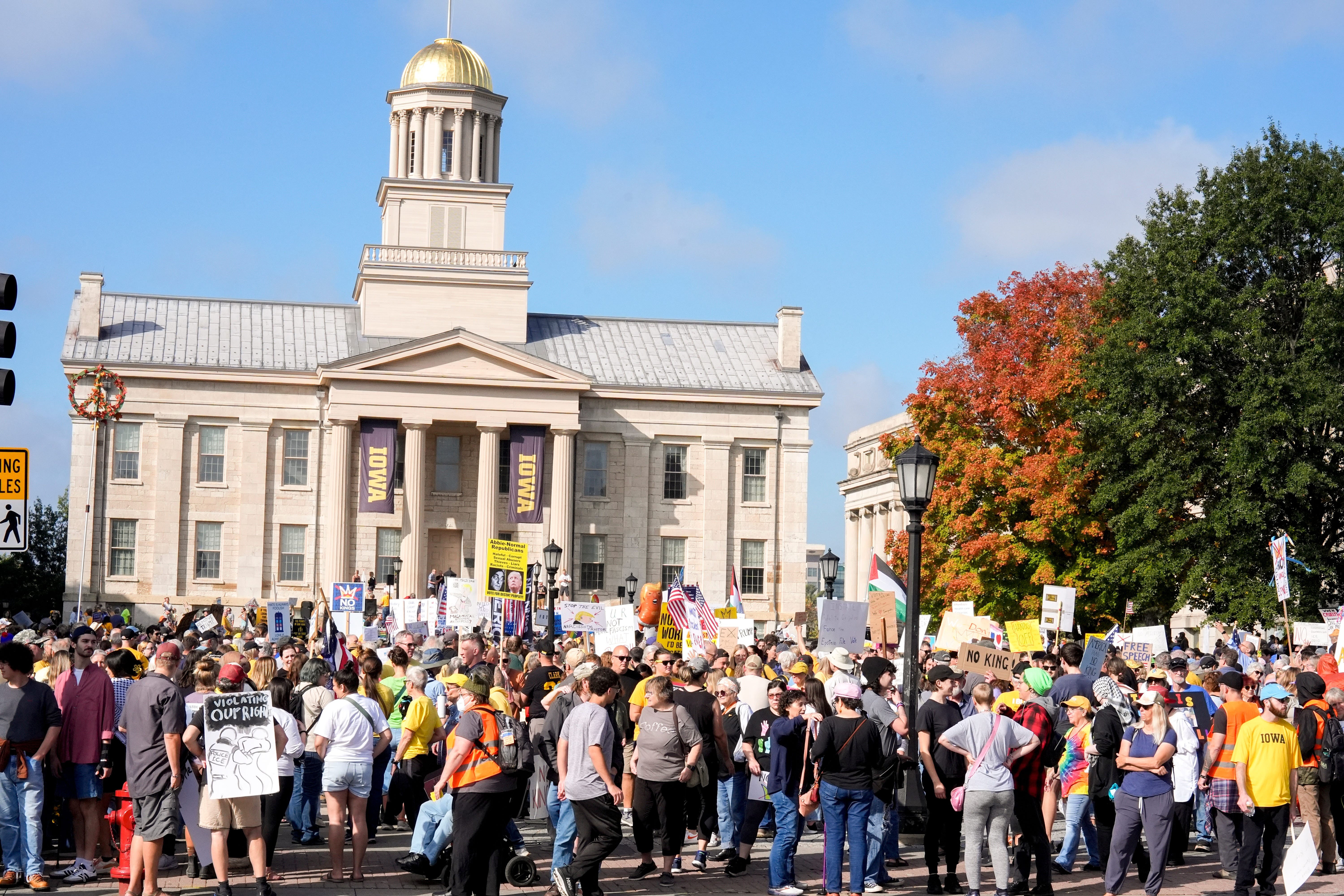 A group of protesters gathers in front of a building in Iowa City.