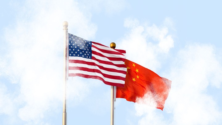 the US and Chinese flags fly in clouds