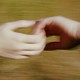 An interracial couple holds hands in a blurry image