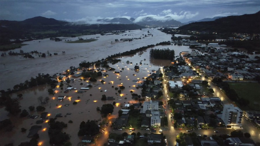 An aerial view of part of a city along a river that has flooded