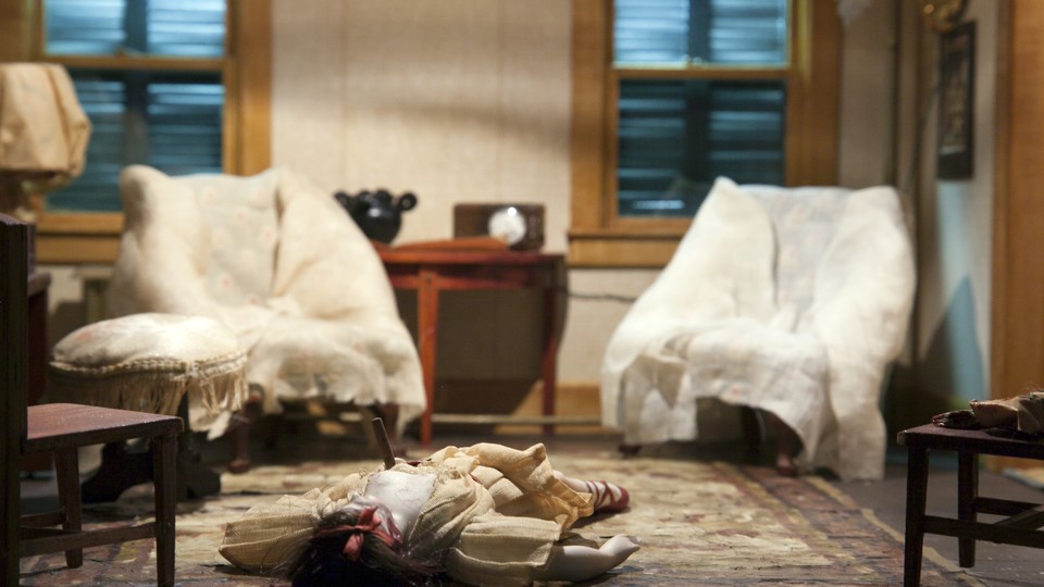 A diorama of a murder scene in a living room