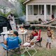 A famile prepares dinner in their front yard after Hurricane Ida.