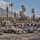 Wildfire damage in Lahaina, Hawaii on Thursday, Aug. 10, 2023; trucks, cars, and palm trees in burned-out areas in western Maui