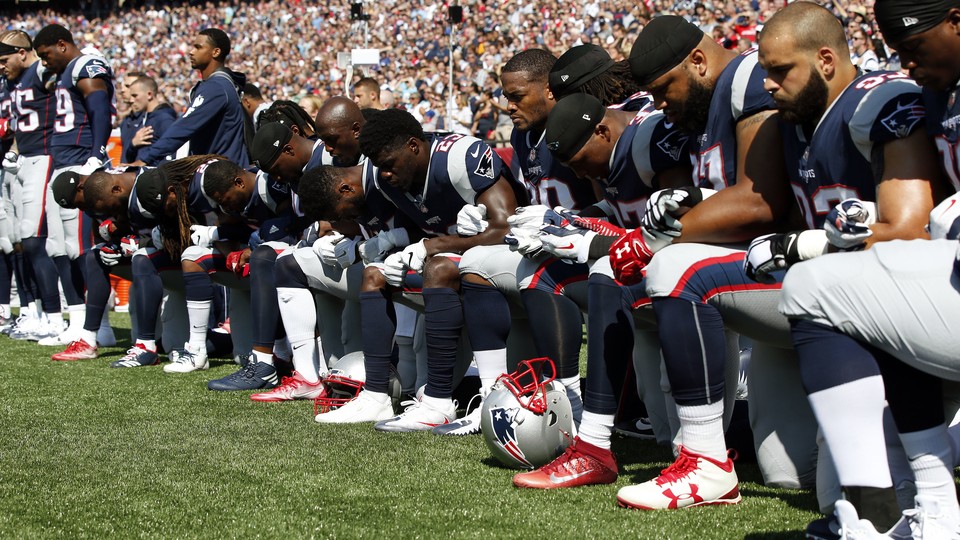 New England Patriots players kneel during the national anthem September 24, 2017.