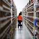 Employee looks for items in an Amazon warehouse