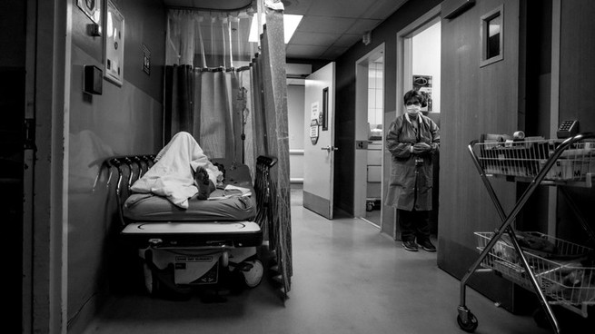 A patient rests in a corridor, waiting for a room at Providence Cedars-Sinai Tarzana Medical Center in California on January 3, 2021.