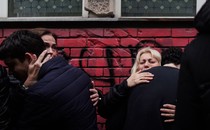 People react outside the Vladislav Ribnikar elementary school in Serbia's capital, Belgrade, on May 4, 2023, a day after a 13-year-old suspect shot dead eight fellow students and a security guard after allegedly drawing up a kill list