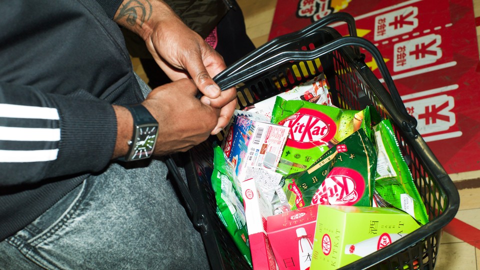 A person carries a grocery basket of KitKats.
