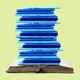 a stack of laptops on top of an open book