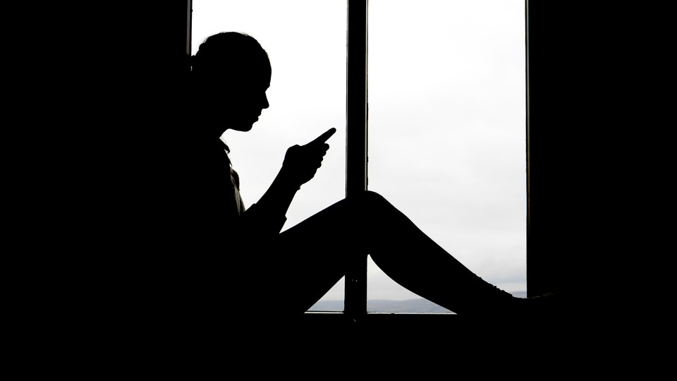 A person sitting on her phone