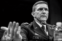 black-and-white photo of Michael Flynn in uniform testifying at a microphone