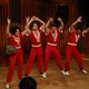 Molly Shannon and the three Jonas Brothers in matching red pantsuits
