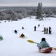 People compete during a snow-kayak downhill race near Otepää, Estonia, in 2013.