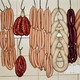 Sausages hang on meat hooks